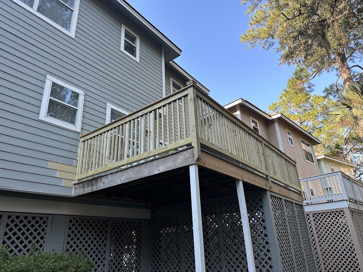 Same elevated deck rebuilt with new pressure-treated framing, decking and railings