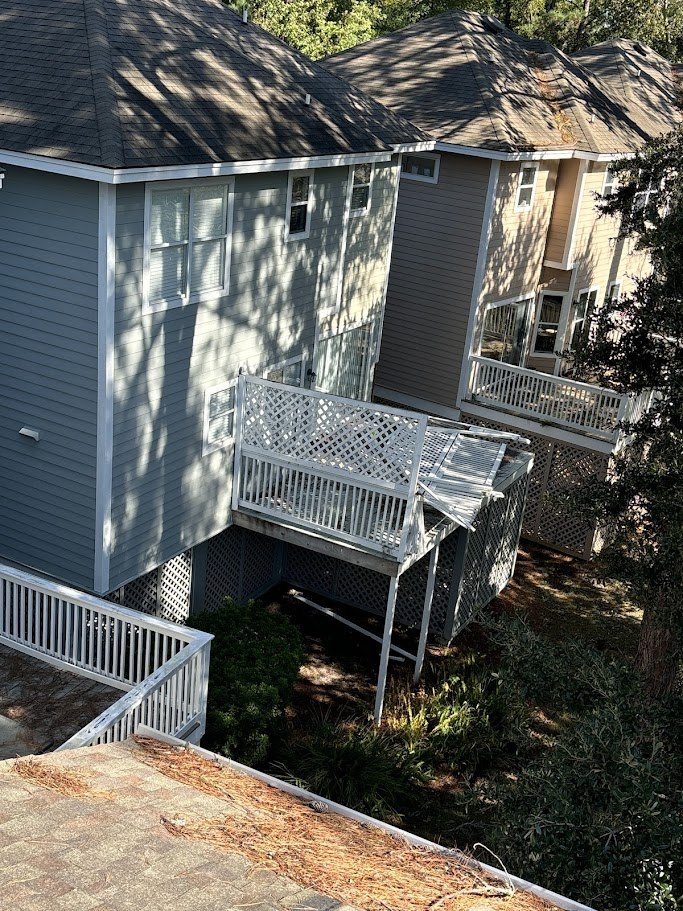 Elevated rear deck collapsed by storm damage, railing and lattice torn away